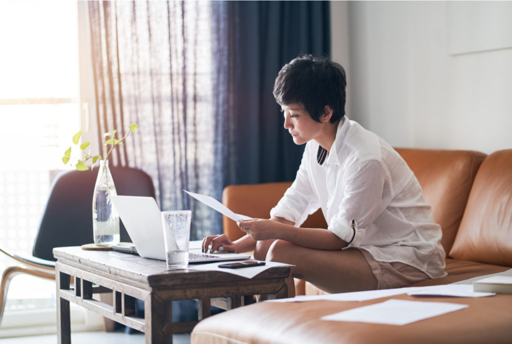 A self-employed woman checks work on her laptop